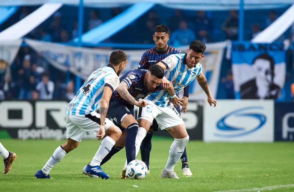 Nahuel Bustos, rodeado, en el partido que Talleres afrontó en Tucumán ante Atlético. (Prensa Talleres)