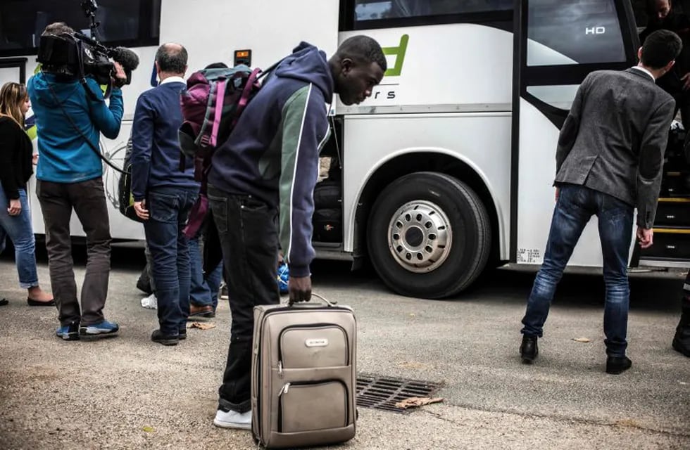 Migrants arrive by bus from the Calais Jungle, on October 24, 2016 at the Montlaville castle in Chardonnay.nFrench authorities began on October 24, 2016 moving thousands of people out of the notorious Calais Jungle camp before demolishing the camp that has served as a launchpad for attempts to sneak into Britain. Migrants lugging meagre belongings boarded buses taking them away from Calais' 