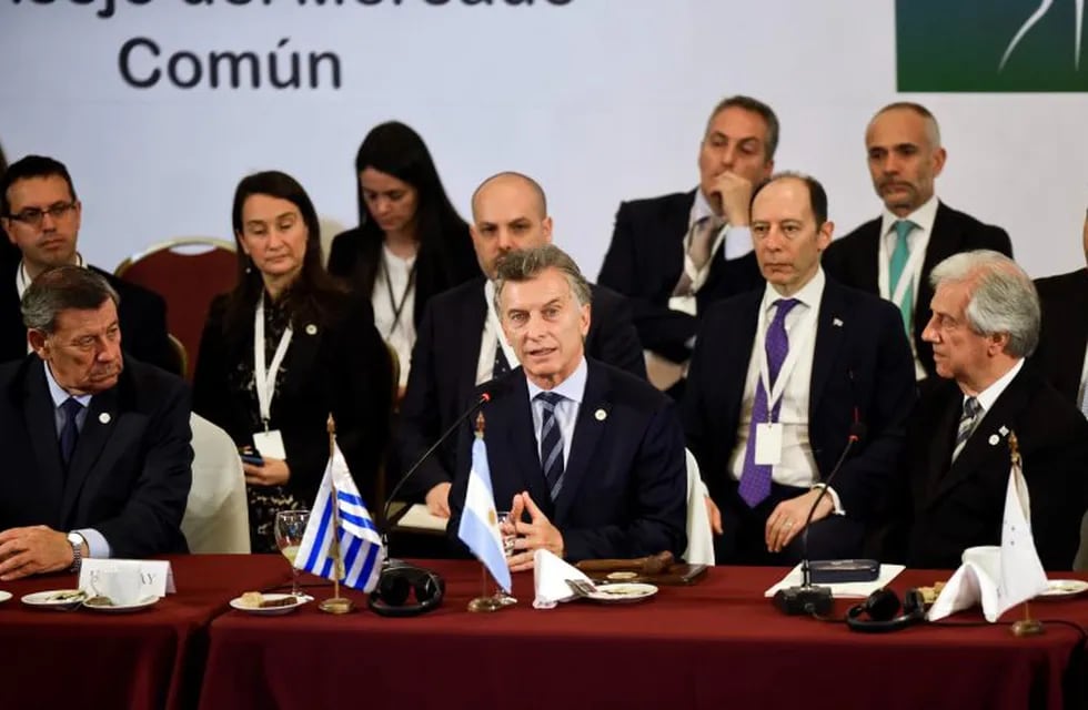 FILE - In this Dec. 18, 2018 file photo, Argentina's President Mauricio Macri speaks as the new pro tempore president of Mercosur, flanked by Uruguay's Foreign Affairs Minister, Rodolfo Nin, left and Uruguay's President Tabare Vazquez, right, at the 53rd Mercosur Summit in Montevideo, Uruguay. Argentina's Foreign Ministry said in a statement Friday, June 28, 2019, that South America's Mercosur trade bloc has struck a \