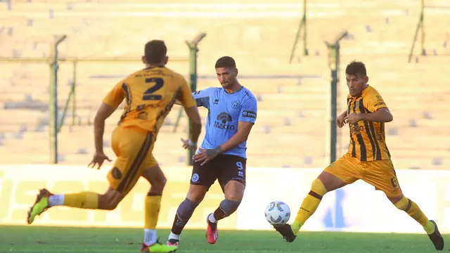 Lucas Passerini, delantero de Belgrano, trata de jugar ante los defensores de Mitre de Santiago del Estero