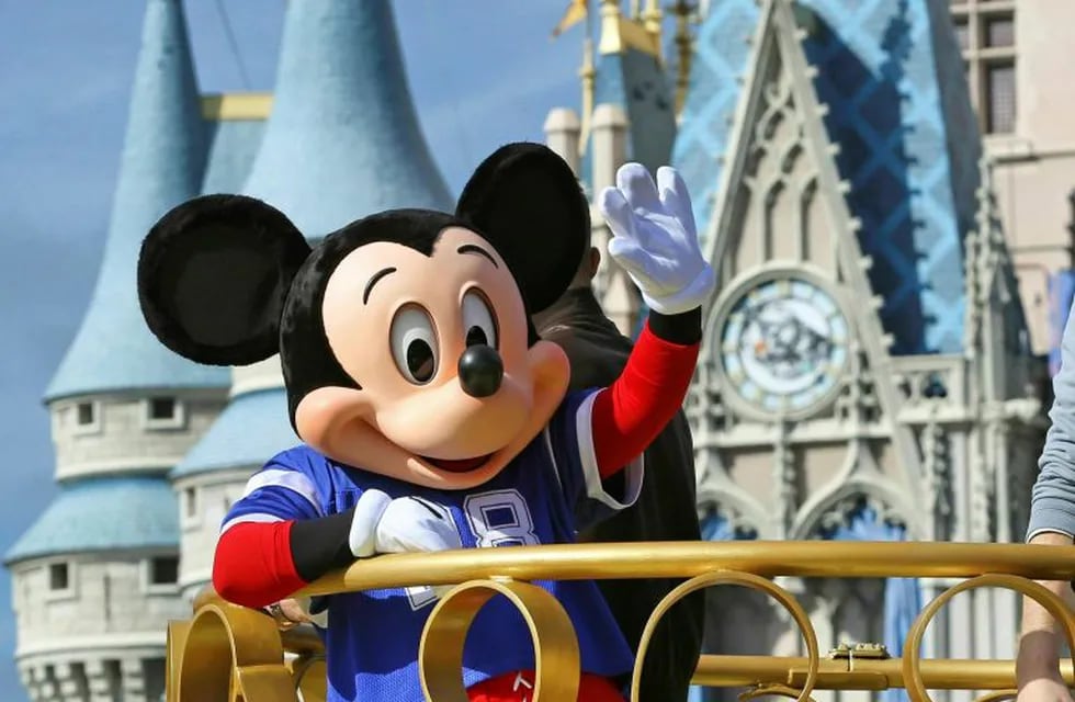 FILE - In this Feb. 4, 2019, file photo, Mickey Mouse celebrates the Super Bowl winning team, the New England Patriots, during the Super Bowl victory parade in the Magic Kingdom at Walt Disney World in Lake Buena Vista, Fla. Months after workers who play Mickey Mouse and Goofy at Walt Disney World threatened to leave the Teamsters union because of what they called \