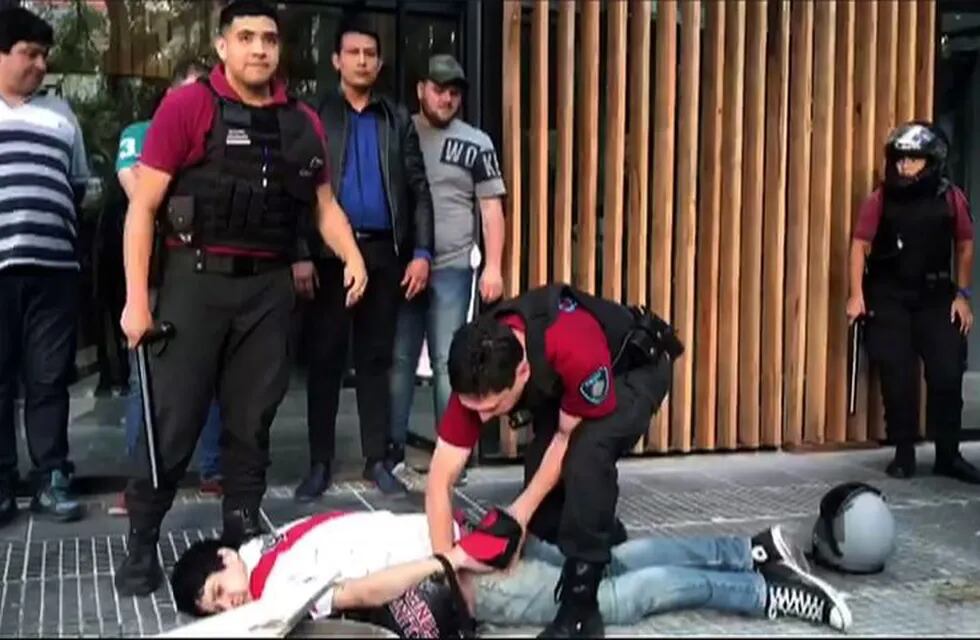 Video grab showing security forces arresting a supporter of River Plate during clashes in the surroundings of the Monumental stadium in Buenos Aires following an attack on the Boca team bus before the all-Argentine Copa Libertadores second leg final match between River Plate and Boca Juniors on November 24, 2018. - Saturday's \