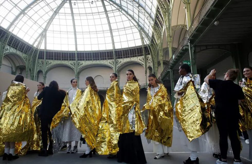 FILE - In this Jan. 21, 2020 file photo, models wait before the presentation of Chanel Haute Couture Spring/Summer 2020 fashion collection, in Paris. The coronavirus pandemic has instilled extra unpredictability into the already fickle Paris Fashion Week. After first canceling the July shows for menswear and Haute Couture, the French fashion federation has now organized an unprecedented schedule of digital-only events instead. (AP Photo/Thibault Camus, File)