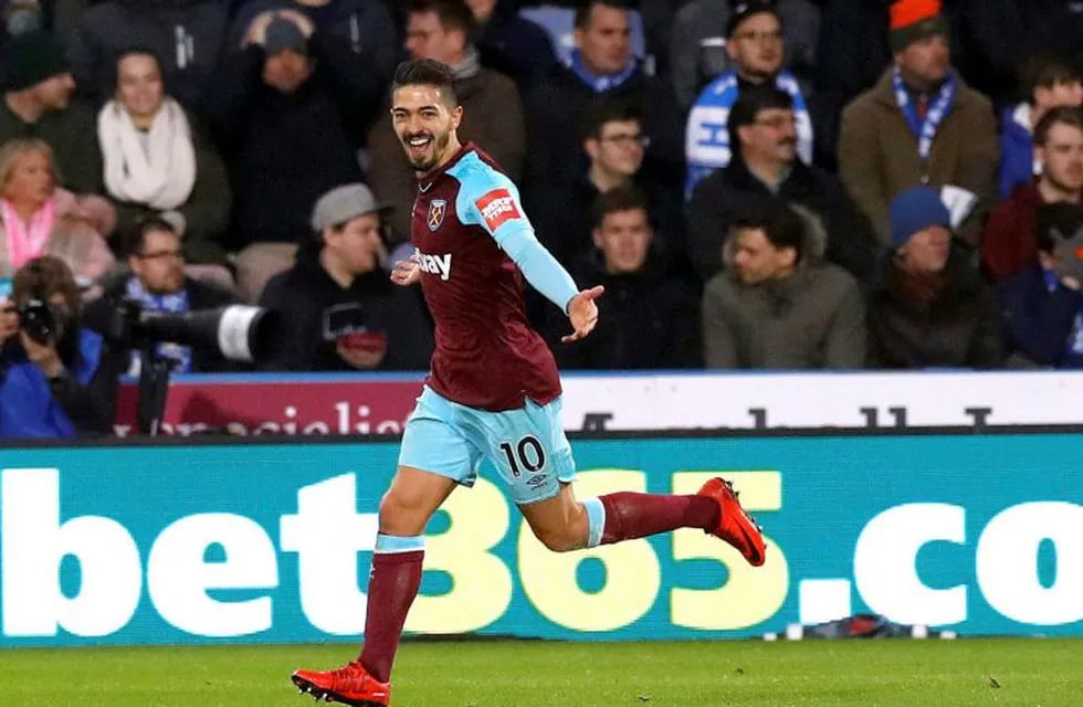 West Ham United's Manuel Lanzini celebrates scoring his side's fourth goal of the game against Huddersfield Town during the English Premier League soccer match against West Ham United at the John Smith's Stadium, Huddersfield, England, Saturday Jan. 13, 2018. (Martin Rickett/PA via AP)