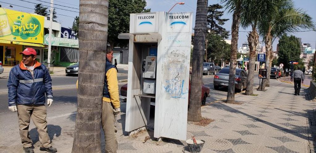 Empleados municipales removiendo cabinas telefónicas de las calles