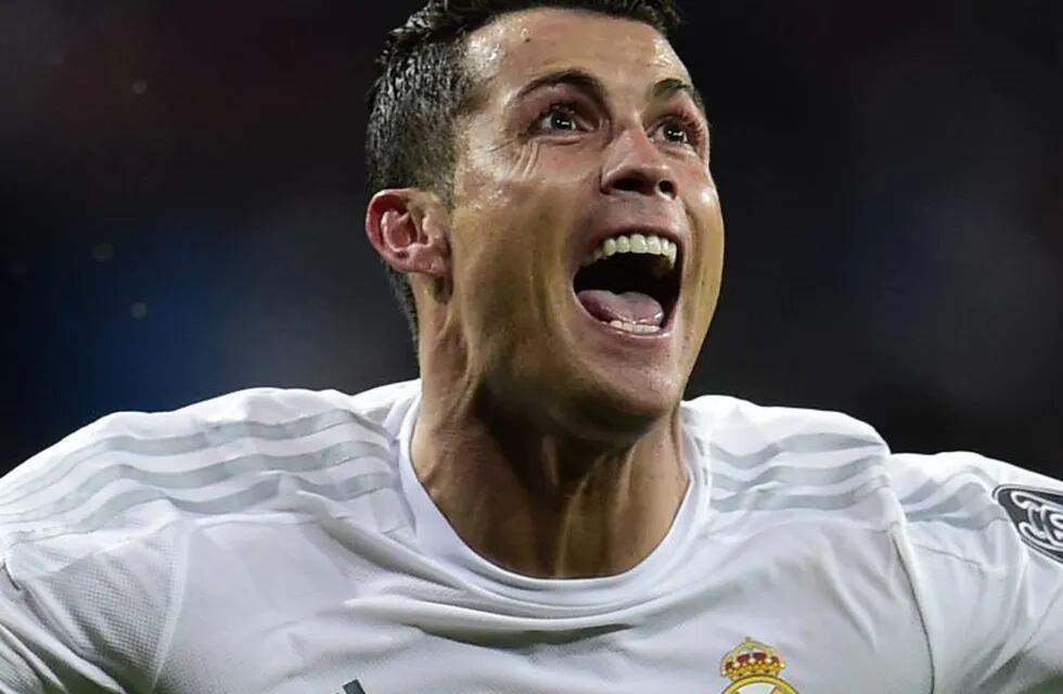 (FILES) This file photo taken on April 12, 2016 shows Real Madrid's Portuguese forward Cristiano Ronaldo celebrating after scoring his third goal during the Champions League quarter-final second leg football match Real Madrid vs Wolfsburg at the Santiago Bernabeu stadium in Madrid on April 12, 2016.nCristiano Ronaldo looks set to retire at Real Madrid after agreeing a bumper new five-year contract to be signed on November 7, 2016 that ties him to the Spanish giants until 2021. / AFP PHOTO / JAVIER SORIANO