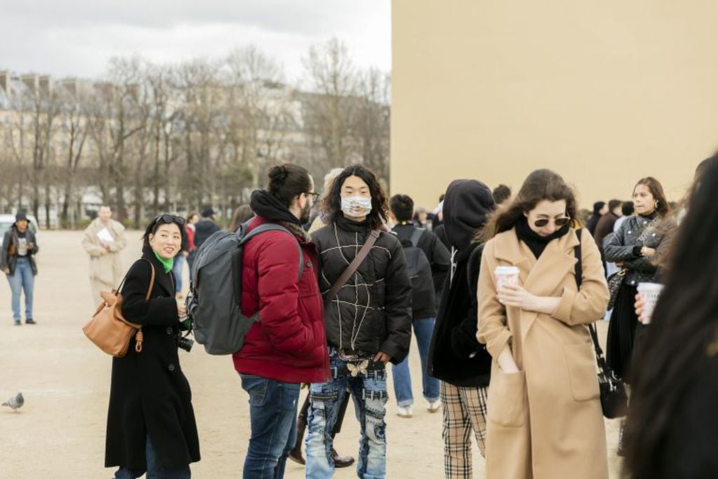 Turistas usando barbijos en la Fashion Week de París.