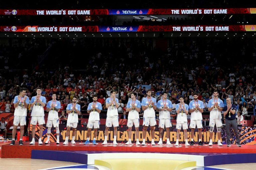 Argentina's team stand with their silver medals after their loss to Spain in their first-place match in the FIBA Basketball World Cup at the Cadillac Arena in Beijing, Sunday, Sept. 15, 2019. (AP Photo/Mark Schiefelbein)