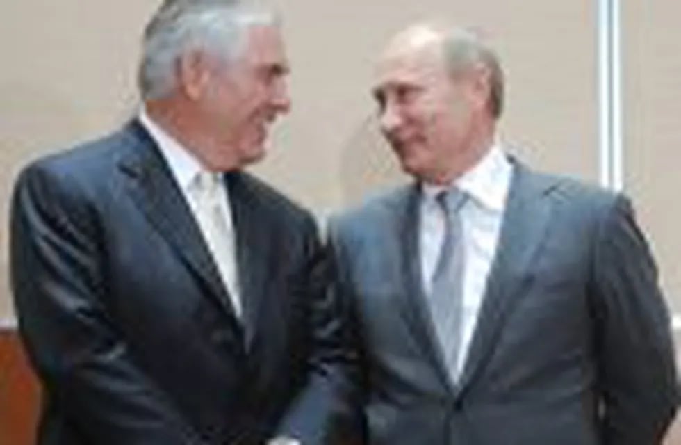 (FILES) This file photo taken on August 30, 2011 shows nRussia's Prime Minister Vladimir Putin (L) speaking with ExxonMobil President and Chief Executive Officer Rex Tillerson during the signing of a Rosneft-ExxonMobil strategic partnership agreement in Sochi on August 30, 2011. nPresident-elect Donald Trump on Tuesday tapped ExxonMobil chief Rex Tillerson, an oilman with deep ties to Russia, as his secretary of state.nTillerson's nomination comes just days after a secret CIA report accused Russia of interfering with the US election in favor of Trump, in a development which could complicate his confirmation. / AFP PHOTO / RIA NOVOSTI / ALEXEY DRUZHININ