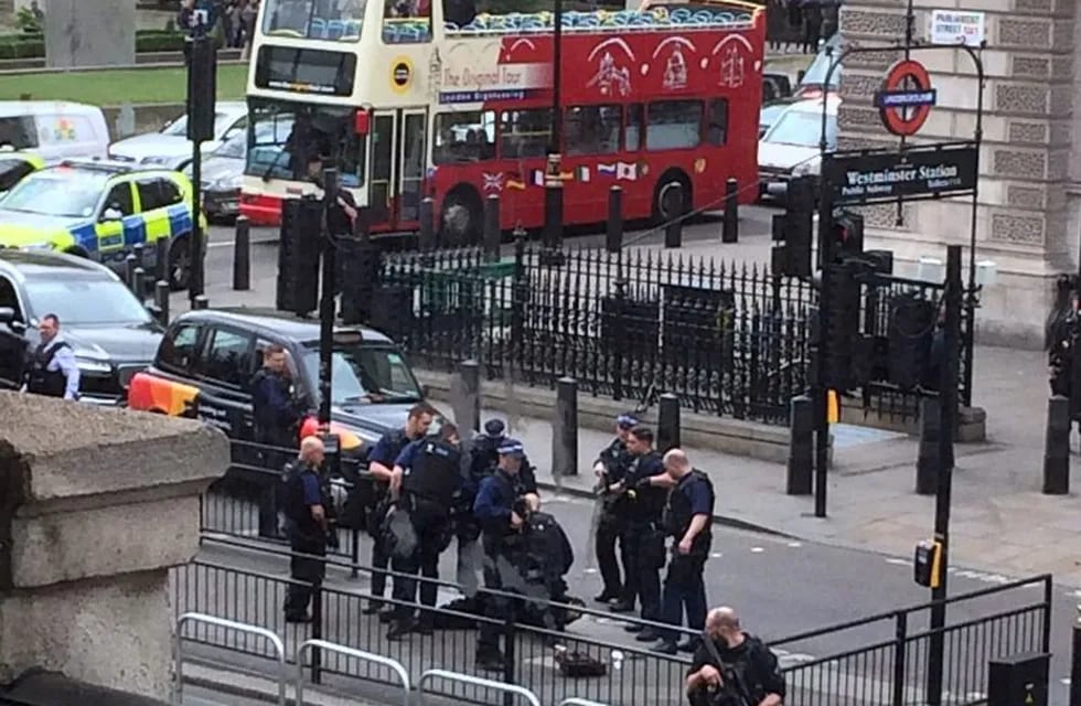 Police arrest a man on the pavement in Whitehall, London, Thursday April 27, 2017. London police say they have arrested a man for possession of offensive weapons near Britain's Houses of Parliament. (Dev Howard via AP)