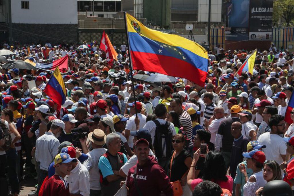 Seguidores del jefe del Parlamento venezolano, Juan Guaidó, escuchan su discurso este lunes, después de que regresara de una gira por Suramérica, en el barrio Las Mercedes, en Caracas. (Foto: EFE/ Rayner Peña)