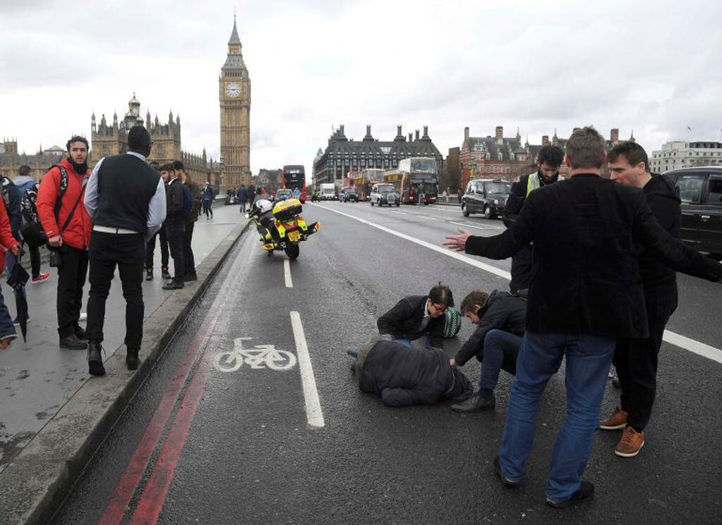 An injured person is assisted after an incident on Westminster Bridge in London, Britain March 22, 2017.  REUTERS/Toby Melville