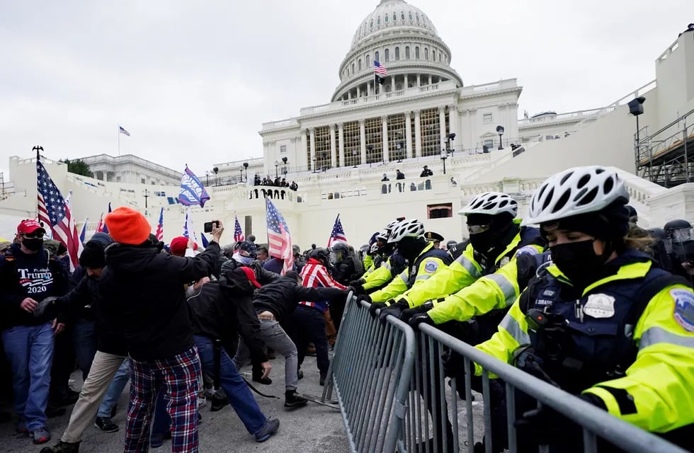 Los partidarios de Trump intentan romper una barrera policial en el Capitolio de Washington. (AP)