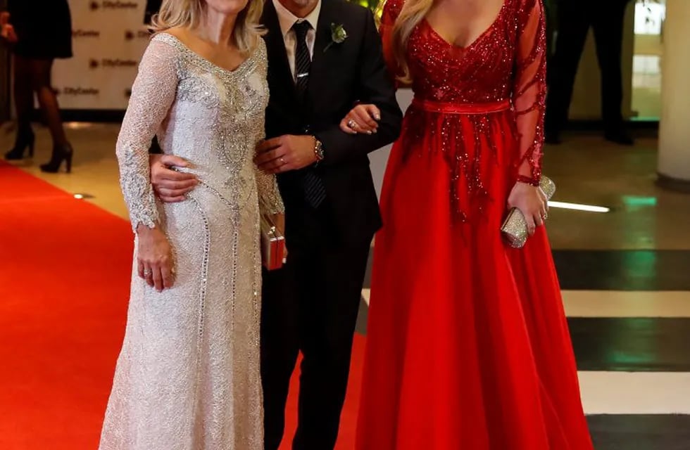 Lionel Messi's family members, from left to right, mother Celia Maria Cuccittini, father Jorge Messi, and sister Maria Sol, pose on the red carpet after the soccer superstar wed his childhood sweetheart Antonella Roccuzzo, in Rosario, Argentina, Friday, June 30, 2017. About 250 guests, including teammates and former teammates of the Barcelona soccer star, attended the highly anticipated ceremony. (AP Photo/Victor R. Caivano)