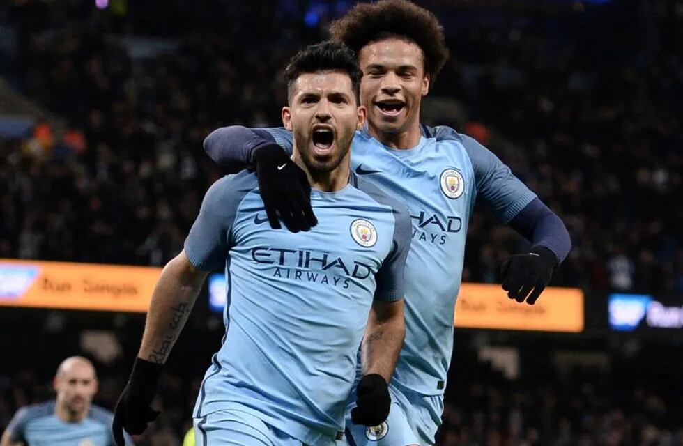 Manchester City's Argentinian striker Sergio Aguero (L) celebrates scoring his team's second goal during the FA Cup fourth round replay football match between Manchester City and Huddersfield Town at the Etihad Stadium in Manchester, north west England, o