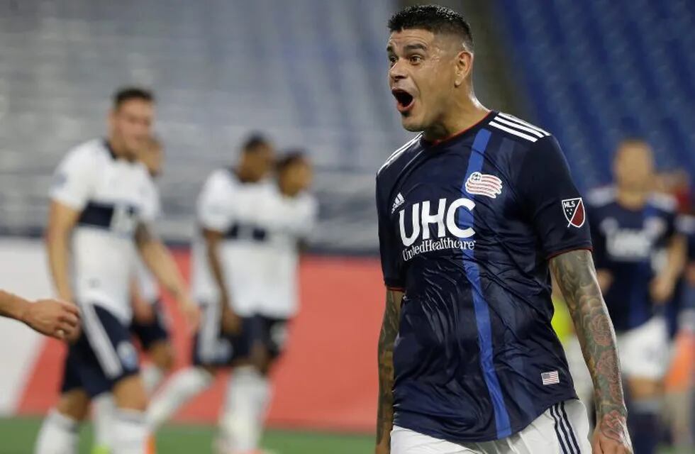 New England Revolution's Gustavo Bou, right, celebrates after scoring in the first half of an MLS soccer match against the Vancouver Whitecaps, Wednesday, July 17, 2019, in Foxborough, Mass. (AP Photo/Steven Senne)