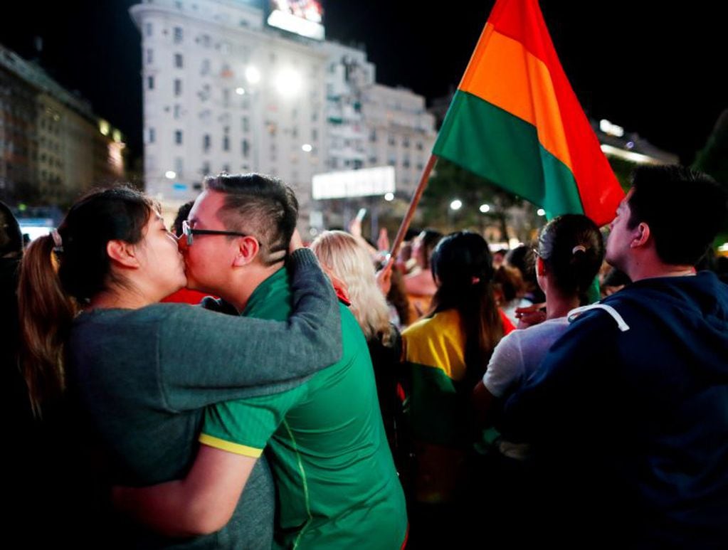 A couple of Bolivian residents in Argentina kiss each other during a demonstration against Bolivian President Evo Morales, in Buenos Aires, Argentina November 10, 2019. REUTERS/Agustin Marcarian