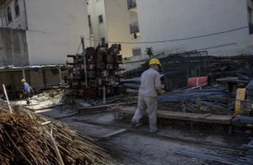 Workers stack pile metal parts at the construction site for the Hornos 330 Master Office 3 building development in Buenos Aires, Argentina, on Friday, Nov. 25, 2016. The Argentina National Institute of Statistics and Censuses (INDEC) is scheduled to relea