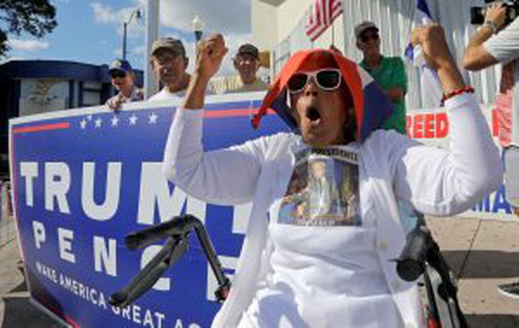 Cuban-American Ana Acosta Ayon chants pro Trump slogans, Friday, Jan. 20, 2017, in the Little Havana area in Miami, before President-elect Donald Trump is sworn in as the 45th president of the United States. (AP Photo/Alan Diaz)