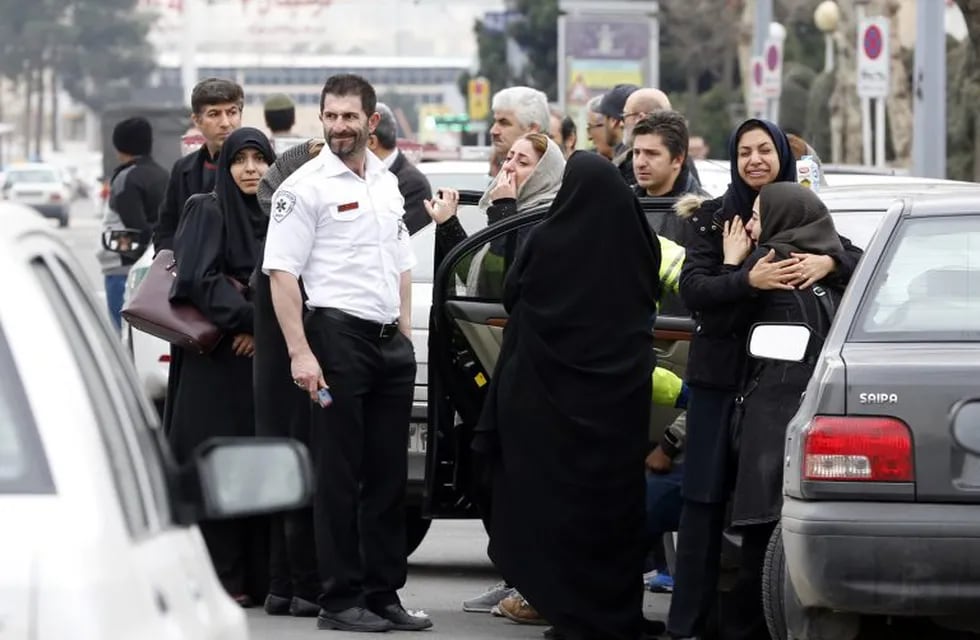 Relatives of Iranian passengers, onboard the Aseman Airlines flight EP3704, react as they gather in front of a mosque near Tehran's Mehrabad airport on February 18, 2018. \nAll 66 people on board an Iranian passenger plane were feared dead after it crashed into the country's Zagros mountains, with emergency services struggling to locate the wreckage in blizzard conditions.  / AFP PHOTO / ATTA KENARE