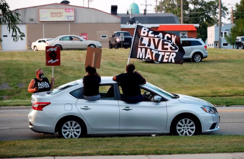 Protesters march to demonstrate against the shooting of Jacob Blake who was shot in the back multiple times by police the day before, prompting community protests in Kenosha, Wisconsin on August 24, 2020. - Police faced off with hundreds of peaceful protesters ahead of a curfew in this city in Wisconsin Monday, as rage grew once more in the US at the shooting of a black man by a white officer. (Photo by KAMIL KRZACZYNSKI / AFP)