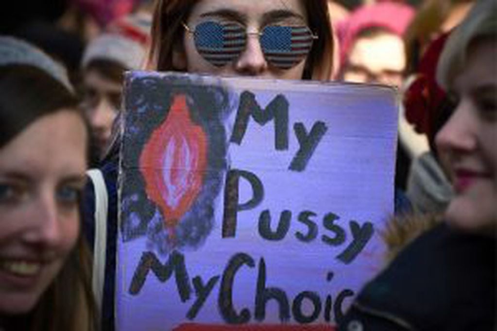 A woman holds a placard reading "My pussy my choice" during a rally in solidarity with supporters of the Women's March taking place in Washington and many other cities on January 21, 2017 in Lyon, southeastern France, one day after the inauguration of the