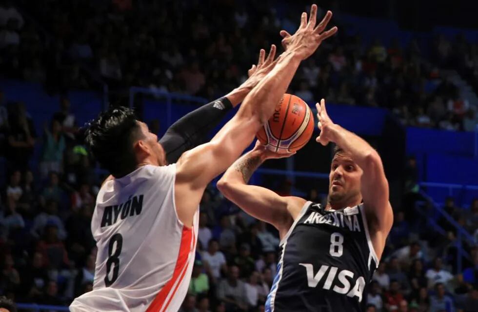 Gustavo Ayon from Mexico, left, blocks Nicolas Laprovittola from Argentina in the fourth quarter of their FIBA basketball World Cup Qualifiers game in Mexico City, Friday, Sep. 14, 2018. (AP Photo/Christian Palma)