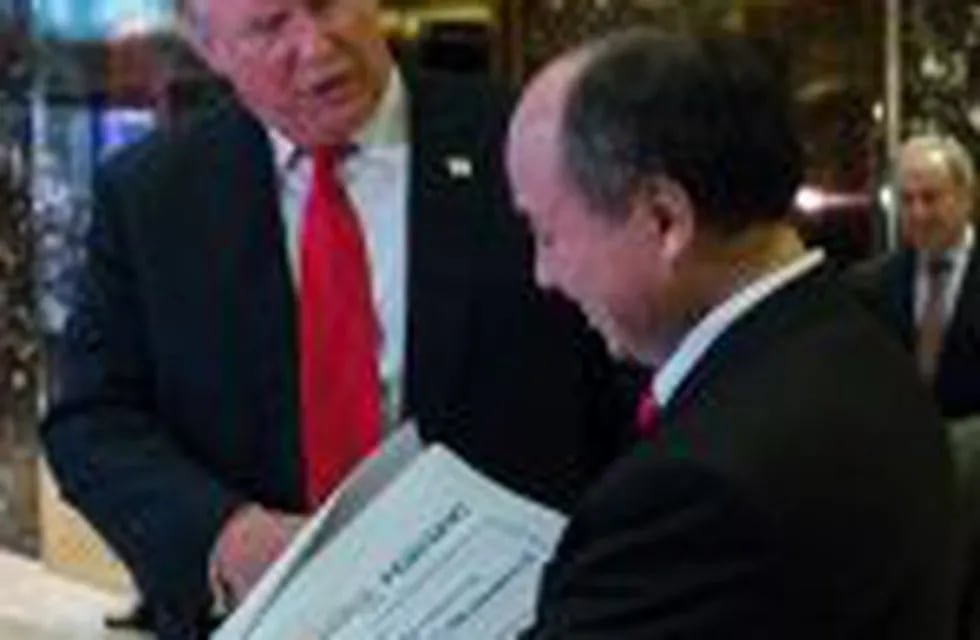 (FILES) This file photo taken on December 6, 2016 showsnPresident-elect Donald Trump exits elevators with SoftBank Group Corp. founder and Chief Executive Officer Masayoshi Son in the lobby of Trump Tower after meetings in New York.nSatellite broadband firm OneWeb on December 19, 2016 announced a $1.2 billion funding round led by SoftBank, the first concrete investment from the Japanese group which made a pledge to President-elect Donald Trump. / AFP PHOTO / EDUARDO MUNOZ ALVAREZ