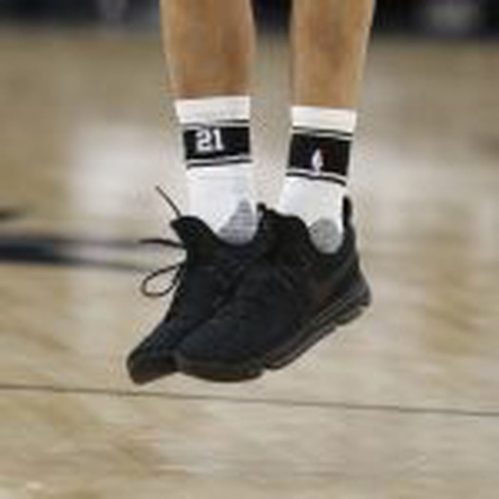 SAN ANTONIO,TX - DECEMBER 18: Manu Ginobili #20 of the San Antonio Spurs wearing socks with Tim Duncan number on a night when he will be honored after the game against the New Orleans Pelicans at AT&T Center on December 18, 2016 in San Antonio, Texas. NOT