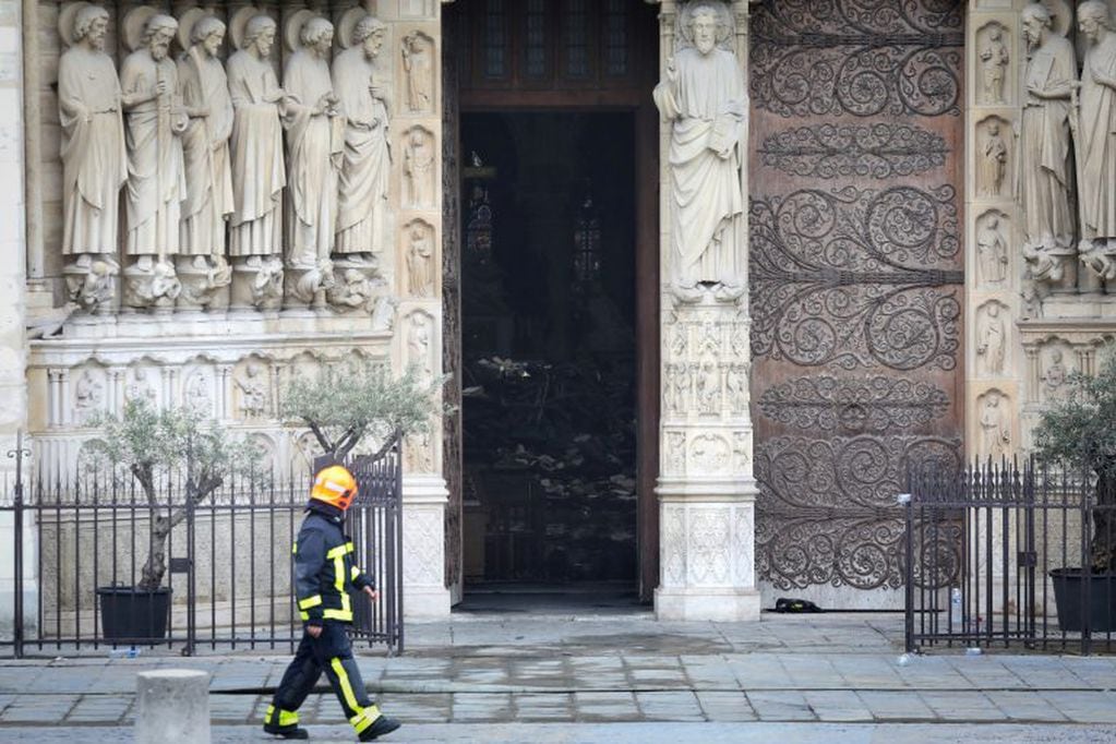 A firefighter walks along Notre-Dame-de Paris in the aftermath of a fire that devastated the cathedral in Paris, France April 16, 2019. Ludovic Marin/Pool via REUTERS