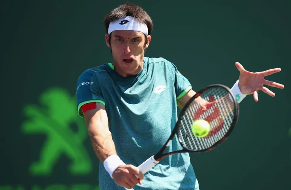 KEY BISCAYNE, FL - MARCH 22: Leonardo Mayer of Argentina plays a backhand against Donald Young of the United States in their first round match during the Miami Open Presented by Itau at Crandon Park Tennis Center on March 22, 2018 in Key Biscayne, Florida.   Clive Brunskill/Getty Images/AFP\n== FOR NEWSPAPERS, INTERNET, TELCOS & TELEVISION USE ONLY ==