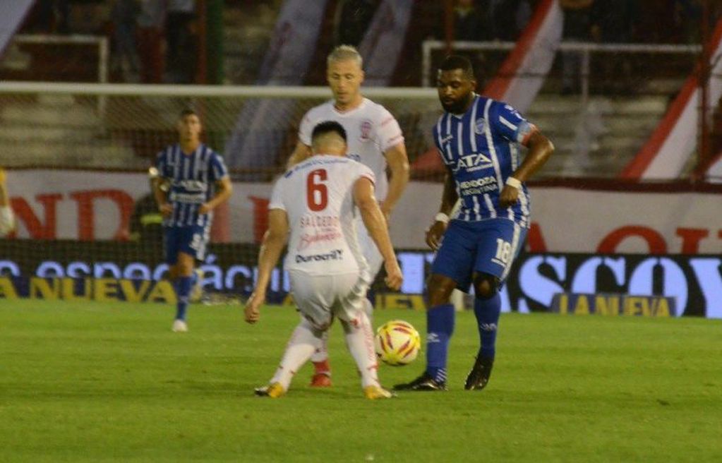 El delantero de Godoy Cruz, "Morro" García, intenta zafar de la marca de Saúl Salcedo de Huracán.