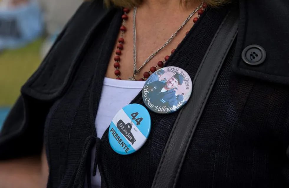 Zulma Sandoval, mother of Argentine missing sub officer Oscar Vallejos, wears a pin with his picture outside Argentina's naval base in Mar del Plata, Buenos Aires province, Argentina, on November 10, 2018. - Vallejos was part of the crew of the Argentine submarine Ara San Juan, which went missing on November 15, 2017. (Photo by Mara SOSTI / AFP)