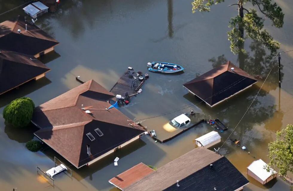 A boat sits near flooded homes in the aftermath of Tropical Storm Harvey in Beaumont, Texas, Thursday, Aug. 31, 2017. (AP Photo/Gerald Herbert)