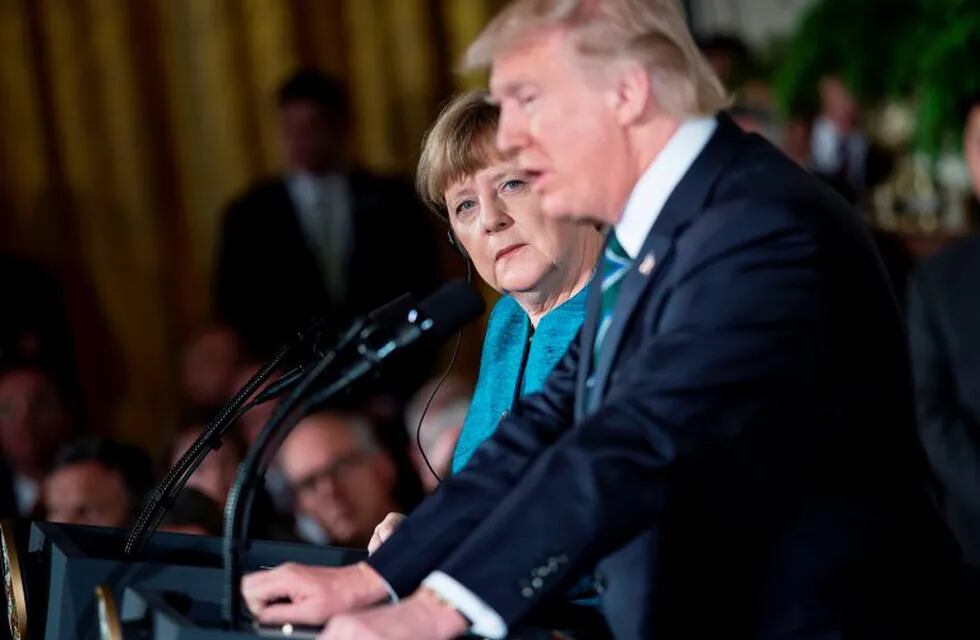 Germany's Chancellor Angela Merkel listens as US President Donald Trump speaks during a press conference in the East Room of the White House March 17, 2017 in Washington, DC. / AFP PHOTO / Brendan Smialowski