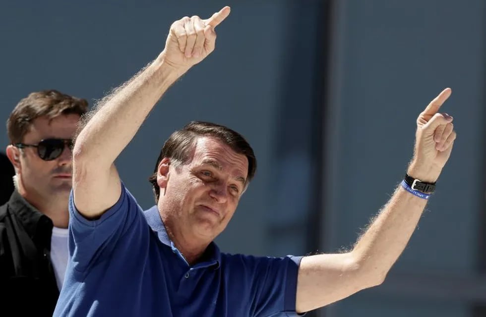 Brazil's President Jair Bolsonaro gestures to supporters during a protest against his former Minister of Justice Sergio Moro and the Supreme Court, in front of the Planalto presidential palace, in Brasilia, Brazil, Sunday, May 3, 2020. (AP Photo/Eraldo Peres)