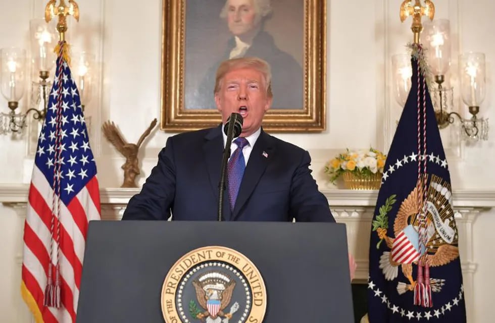 TOPSHOT - US President Donald Trump addresses the nation on the situation in Syria April 13, 2018 at the White House in Washington, DC. Trump said strikes on Syria are under way.  / AFP PHOTO / Mandel NGAN