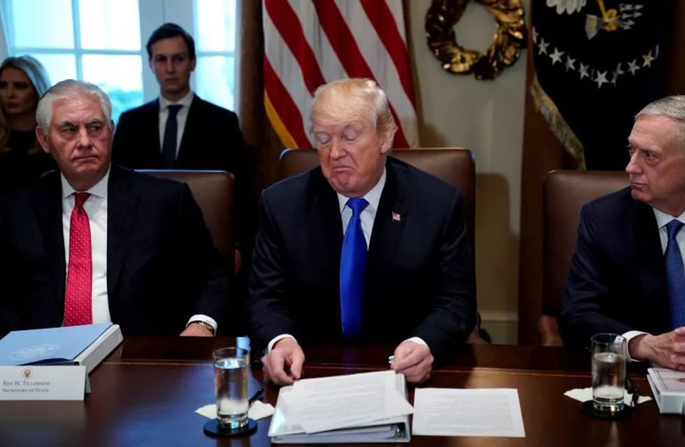 U.S. President Donald Trump, flanked by Secretary of State Rex Tillerson and Defense Secretary James Mattis, holds a cabinet meeting at the White House in Washington, U.S., December 20, 2017. REUTERS/Jonathan Ernst     TPX IMAGES OF THE DAY