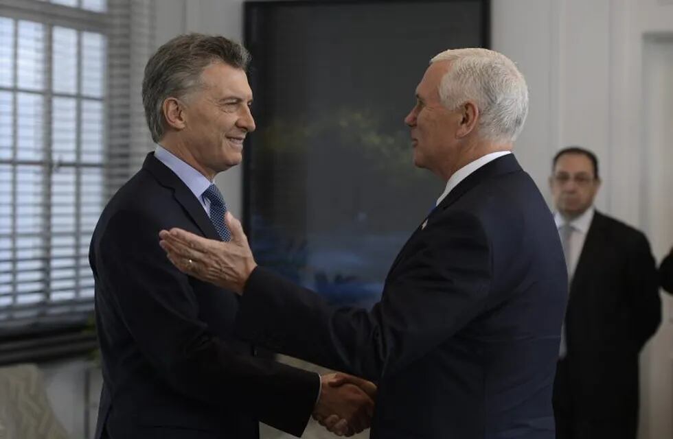 U.S. Vice President Mike Pence, right, shakes hands with Argentina's President Mauricio Macri at the government residence in Buenos Aires, Argentina, Tuesday, Aug. 15, 2017. Pence is on a official visit to Argentina until Wednesday, when he will be heading to Chile on a week-long visit to Latin America. (Juan Mabromata/POOL photo via AP)