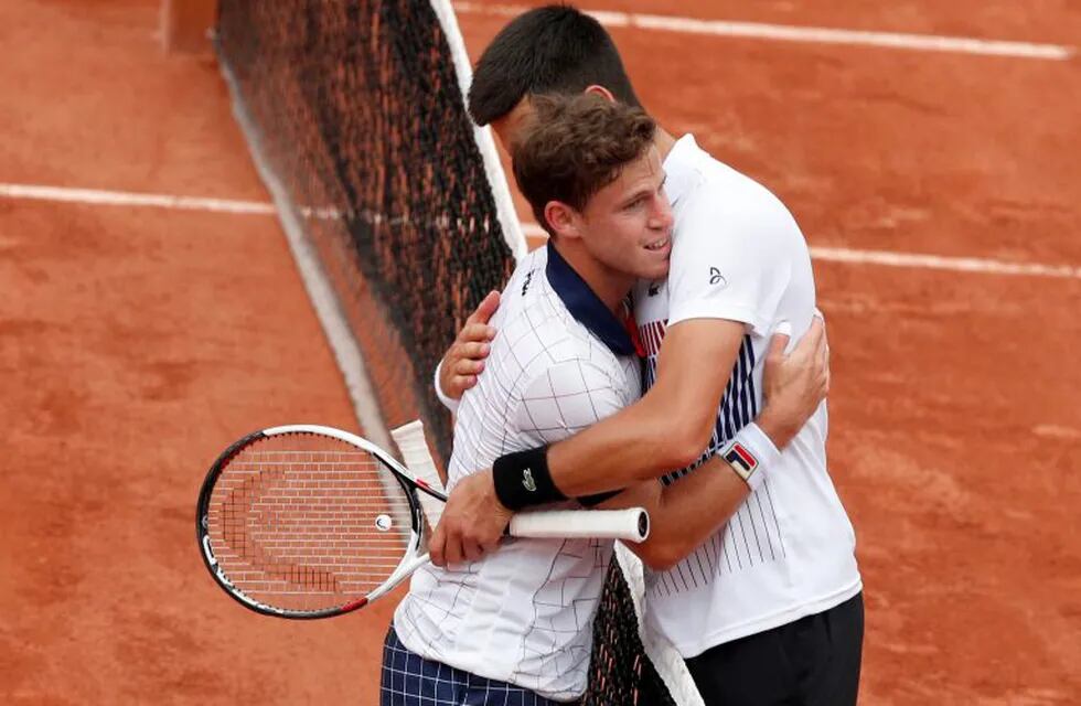 Serbia's Novak Djokovic, right,hugs Argentina's Diego Schwartzman after Djokovic won the third round match in five sets, 5-7, 6-3, 3-6, 6-1, 6-1, at the French Open tennis tournament at the Roland Garros stadium, in Paris, France. Friday, June 2, 2017. (AP Photo/Christophe Ena)