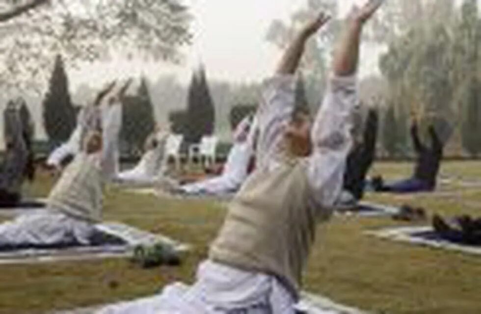 People stretch while performing a yoga pose at Nehru Park in New Delhi, India, on Sunday, Nov. 20, 2016. Yoga and spiritual leaders are lending their names to everything from honey and herbal remedies to toothpaste and clothes. With a ready-made clientele from their vast followers, they are helping to tap surging demand in India for natural and ayurveda-based products to challenge the likes ofUnilever, Colgate-Palmolive Co. and GlaxoSmithKline Plc. Photographer: Udit Kulshrestha/Bloomberg