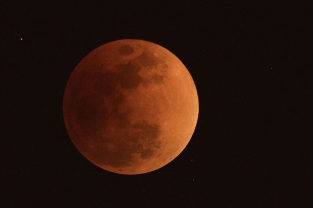 TOPSHOT - The moon is seen during a lunar eclipse, referred to as the "super blue blood moon", in Beijing on January 31, 2018.
Skywatchers were hoping for a rare lunar eclipse that combines three unusual events -- a blue moon, a super moon and a total eclipse -- which was to make for a large crimson moon viewable in many corners of the globe. / AFP PHOTO / NICOLAS ASFOURI