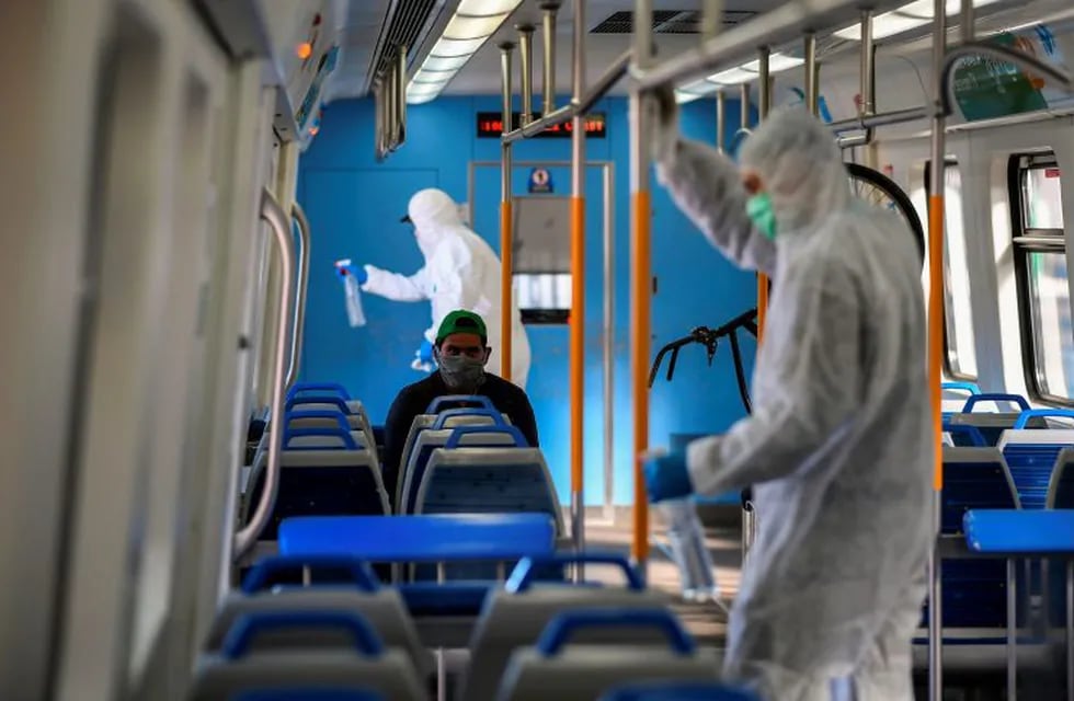 Employees of Trenes Argentinos disinfect and clean a wagon at Constitucion train station, in Buenos Aires, on April 16, 2020 amid the COVID-19 coronavirus pandemic. (Photo by RONALDO SCHEMIDT / AFP)