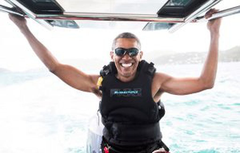 Former U.S. President Barack Obama sits on a boat during a kite surfing outing with British businessman Richard Branson during his holiday on Branson's Moskito island, in the British Virgin Islands, in a picture handed out by Virgin on February 7, 2017. J