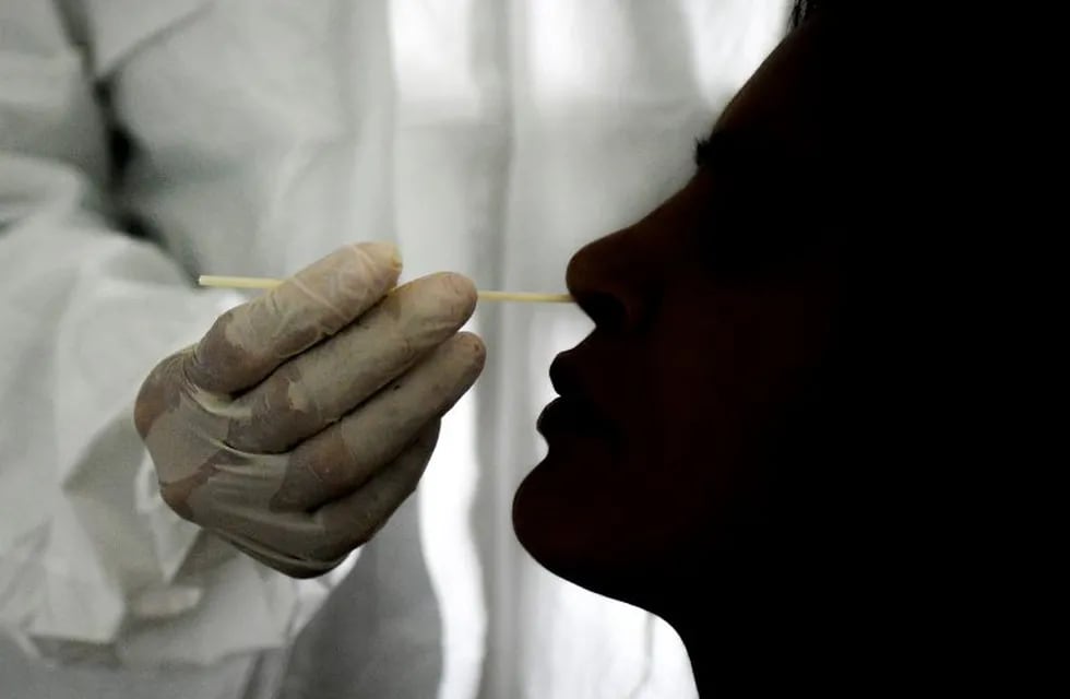 A doctor takes a nasal swab sample to test for COVID-19 at the Cocodrilos Sports Park in Caracas, Venezuela, Saturday, Sept. 19, 2020, amid the new coronavirus pandemic. (AP Photo/Matias Delacroix)