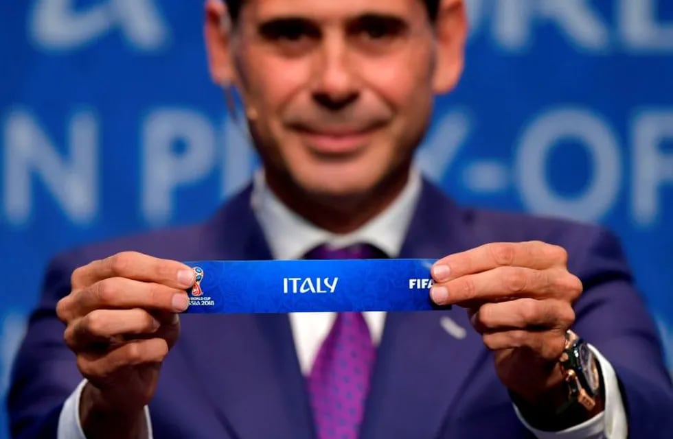 Spanish retired footballer Fernando Hierro shows the name of Italy during the FIFA football World Cup 2018 European play-off draw, on October 17, 2017 in Zurich. / AFP PHOTO / Fabrice COFFRINI