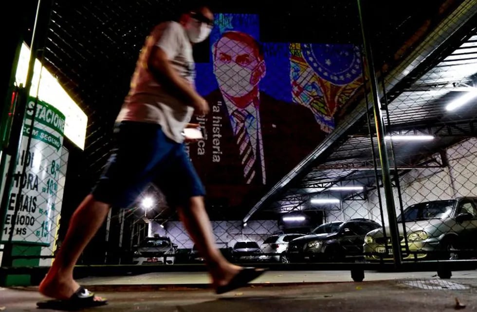 An image of Brazil's President Jair Bolsonaro wearing a protective face mask and the phrase “Hysteria Damages the Economy\