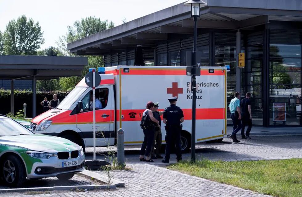 An ambulance stands  near a subway station in Munich, Germany, Tuesday, June 13, 2017.  Several people were injured, including a police officer, in a shooting early Tuesday at a Munich subway station, police said. Munich police spokesman Marcus da Gloria Martins said a female police officer sustained life-threatening injuries after being shot in the head in the incident at the Unterfoehring subway station. The suspect was seriously injured by gunfire, he said. (Sven Hoppe/dpa via AP)