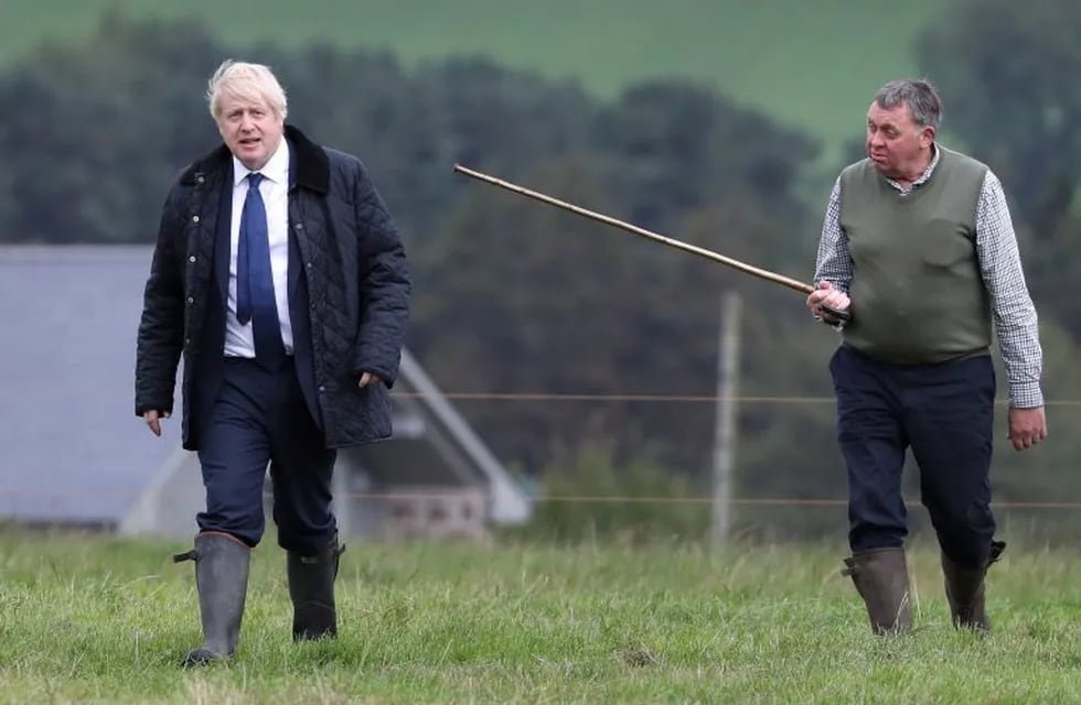 El primer ministro británico, Boris Johnson (izquierda), visita a un granjero local llamado Peter Watson (derecha) en Darnford Farm, cerca de Aberdeen en Escocia, el 6 de septiembre de 2019. Crédito: Andrew Milligan / POOL / AFP.