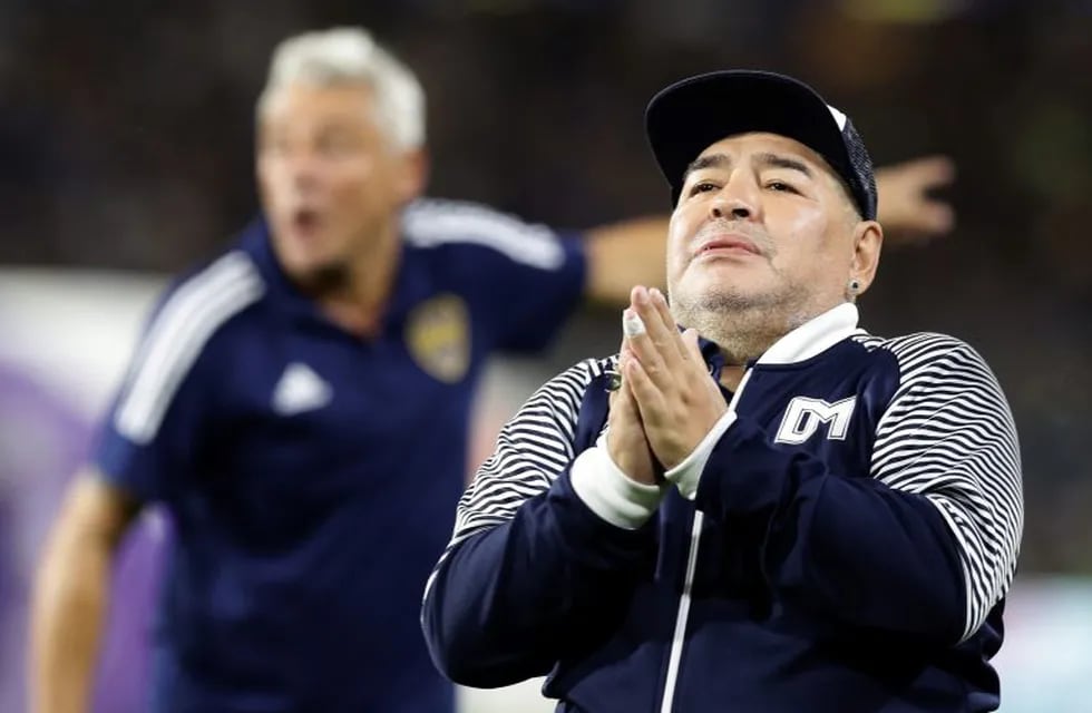 (FILES) In this file photo taken on March 07, 2020 Argentine former football star Diego Maradona acknowledges spectators during an homage before the start of the Argentina First Division 2020 Superliga Tournament football match Boca Juniors vs Gimnasia La Plata, at La Bombonera stadium, in Buenos Aires. - Argentine football great Diego Maradona was admitted to hospital on November 2, 2020 for medical checks, his personal doctor announced. (Photo by ALEJANDRO PAGNI / AFP)